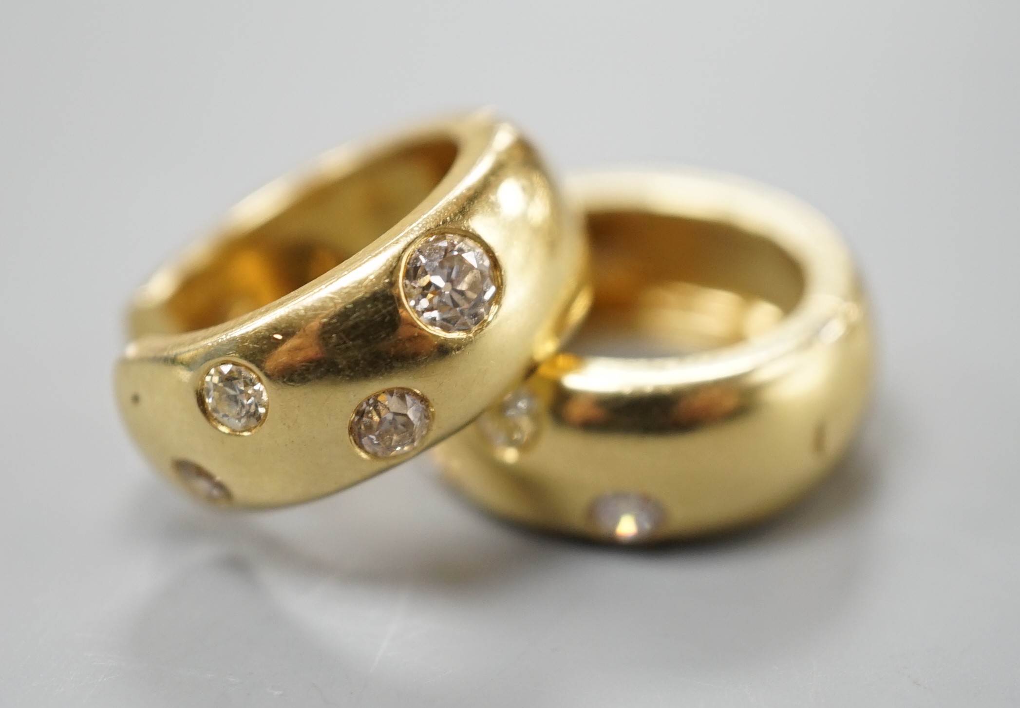 A modern pair of 750 yellow metal and four stone gypsy set diamond hoop earrings, 16mm, gross weight 11 grams.